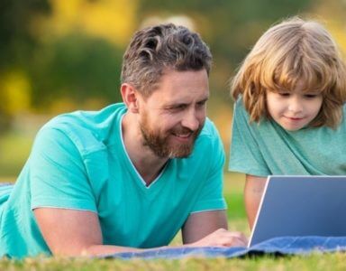 Father and son learning together in summertime