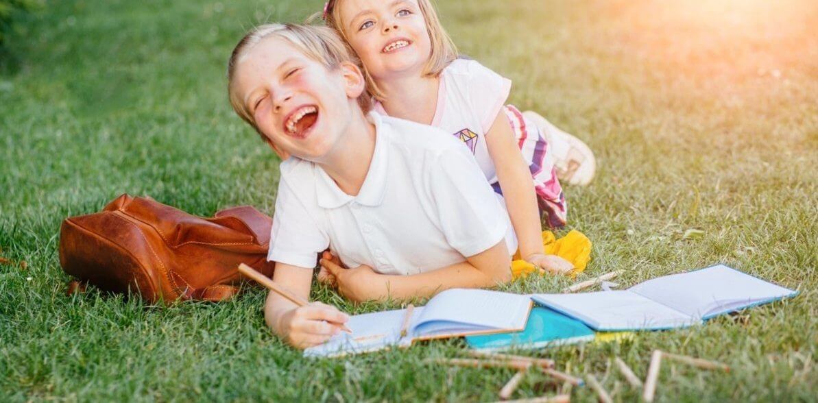 Two children learning outside